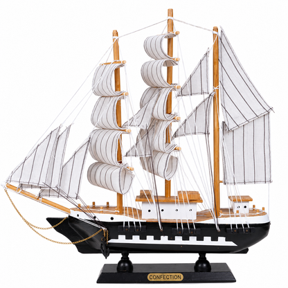 Model ship with white sails on a white background