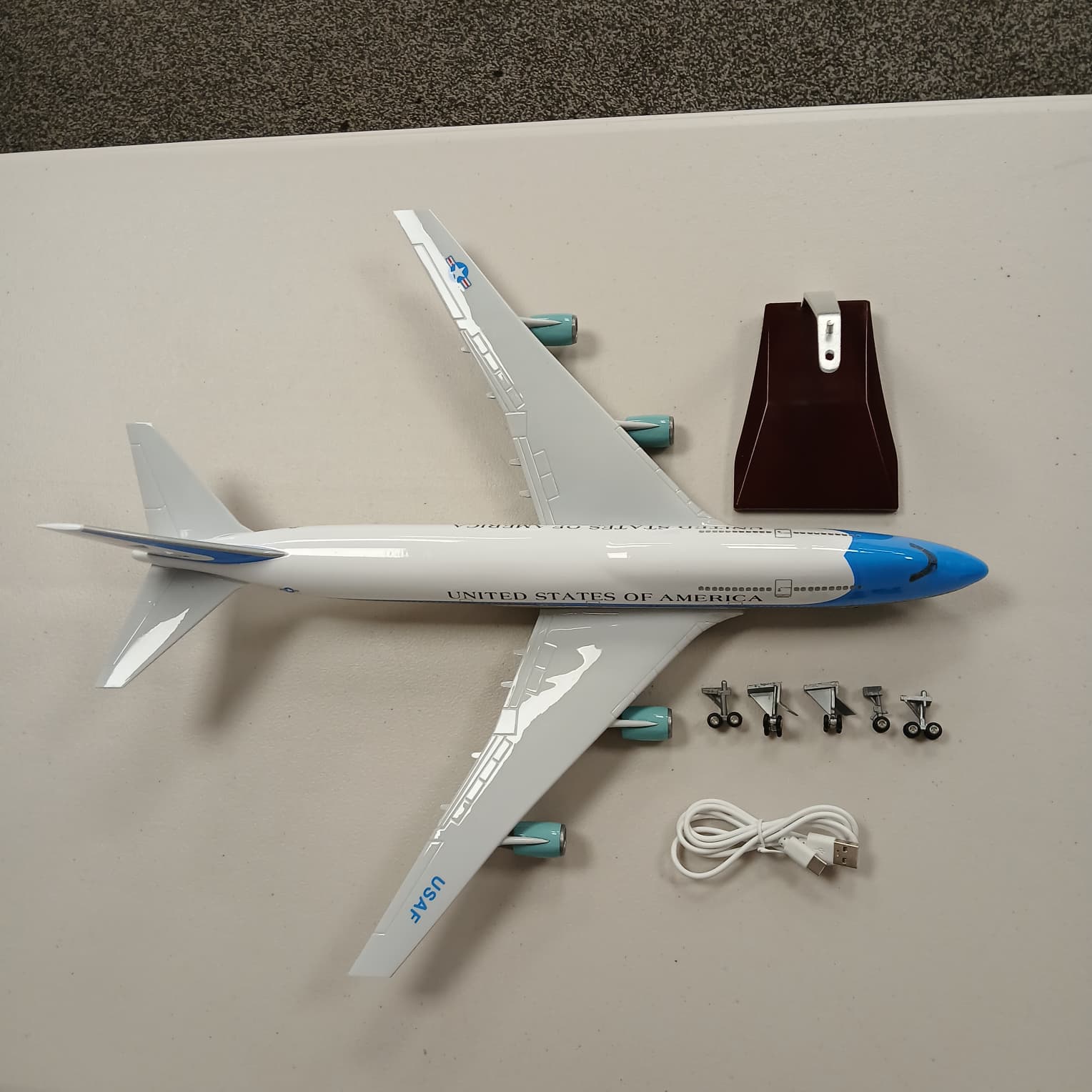 Model airplane with accessories on a gray surface